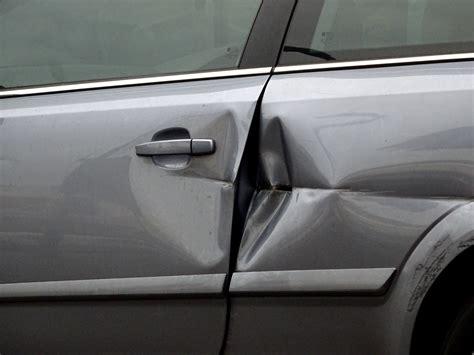 car with small dent on door